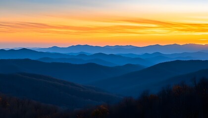 A breathtaking vista of layered mountain ranges at sunrise.