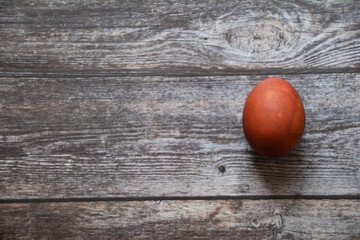 Easter egg on wooden background. Chicken egg on a wooden table