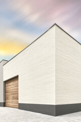 Modern architectural design featuring a smooth-textured wall and wooden garage door near sunset