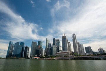 Fototapeta premium Modern Skyscraper in City, Tall Tower with Sleek Glass Windows, Showcasing Urban Architecture Real Estate, Overlooking the Downtown Landscape with Blue Skies and Office Buildings