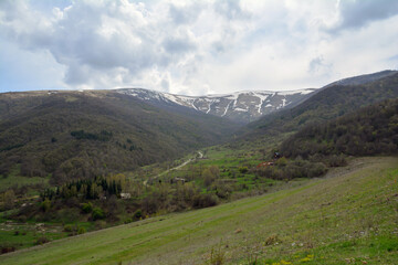 High mountains and green fields. Green forests and beautiful mountains. Mountain landscape