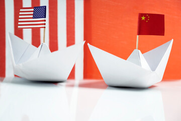 Paper boat with the USA or United States of America and China flags. Concept of the United States...