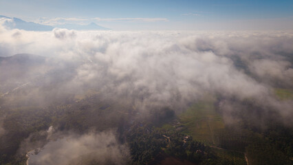 Aerial vire tropical green background of tropical rain forest morning with fog