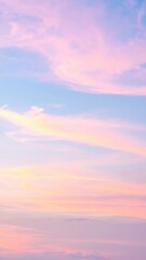 Obraz premium A serene pink sky at dusk, adorned with fluffy white clouds gently illuminated by the fading sunlight, creating a dreamy and tranquil atmosphere.
