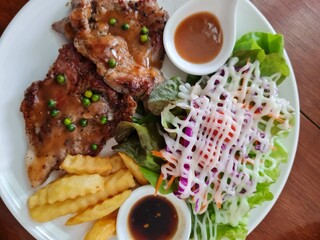 Delicious Grilled Steak with Salad and French Fries
