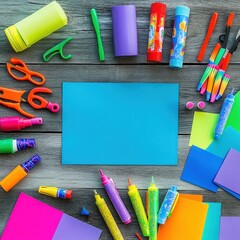 Craft supplies frame blue sheet on wood for school projects or creative art activity top view