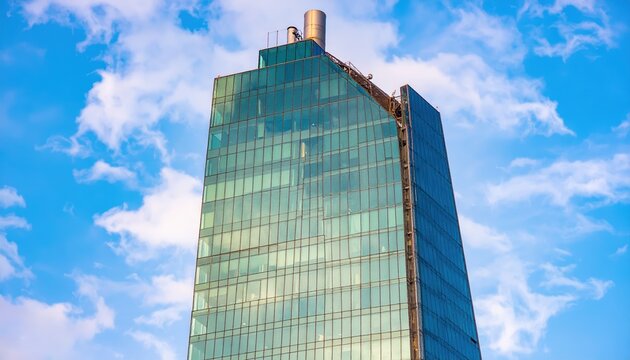 A sleek, modern skyscraper featuring expansive glass windows that reflect the surrounding cityscape, showcasing a vibrant urban environment.