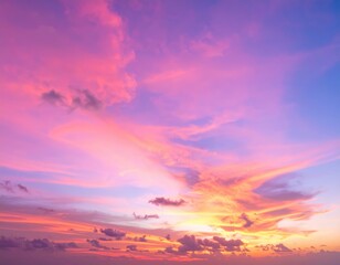 Fototapeta premium A breathtaking sunset paints the sky in vibrant shades of pink, with wispy clouds softly illuminated, creating a serene and dreamy atmosphere.