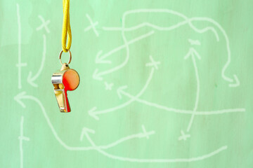 whistle of soccer referee or trainer with soccer tactics scribble on blackboard .Shallow depth of...