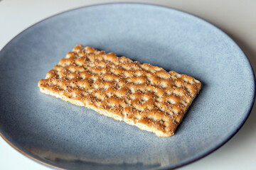 One piece of crunchy crispbread on a plate. High quality photo
