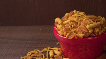 Indian Snacks, Traditional Indian deep fried salty dish called chivda or mixture or farsan made of gram flour and mixed with dry fruits and roasted nuts with salt, pepper, pulses, spice and green peas