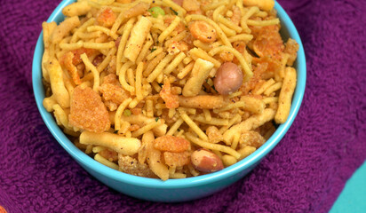 Indian Snacks, Traditional Indian deep fried salty dish called chivda or mixture or farsan made of gram flour and mixed with dry fruits and roasted nuts with salt, pepper, pulses, spice and green peas