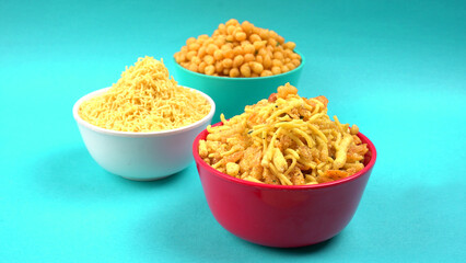 Indian Snacks, Traditional Indian deep fried salty dish called chivda or mixture or farsan made of gram flour and mixed with dry fruits and roasted nuts with salt, pepper, pulses, spice and green peas