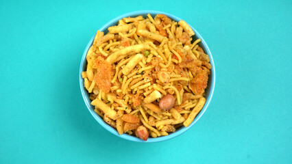 Indian Snacks, Traditional Indian deep fried salty dish called chivda or mixture or farsan made of gram flour and mixed with dry fruits and roasted nuts with salt, pepper, pulses, spice and green peas