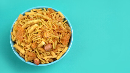 Indian Snacks, Traditional Indian deep fried salty dish called chivda or mixture or farsan made of gram flour and mixed with dry fruits and roasted nuts with salt, pepper, pulses, spice and green peas