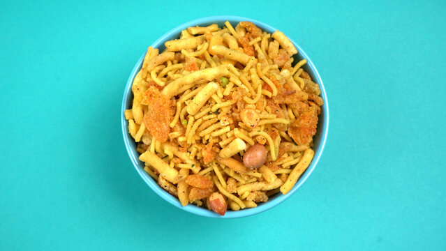 Indian Snacks, Traditional Indian deep fried salty dish called chivda or mixture or farsan made of gram flour and mixed with dry fruits and roasted nuts with salt, pepper, pulses, spice and green peas