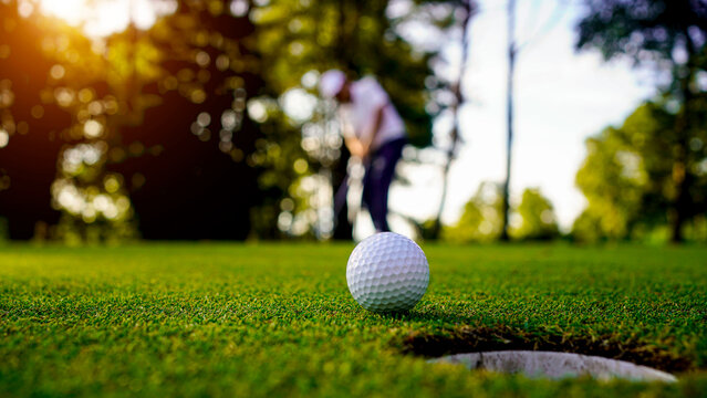 Golfers are putting golf in the evening golf course golf backglound.