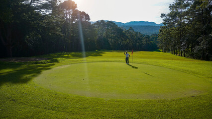 Golfers are putting golf in the evening golf course golf backglound.
