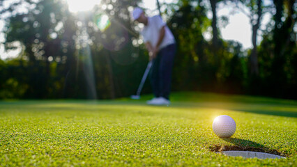 Golfers are putting golf in the evening golf course golf backglound.