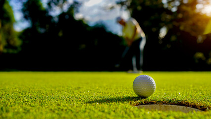 Golfers are putting golf in the evening golf course golf backglound.
