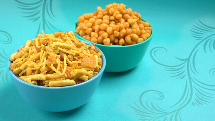 Indian Snacks, Traditional Indian deep fried salty dish called chivda or mixture or farsan made of gram flour and mixed with dry fruits and roasted nuts with salt, pepper, pulses, spice and green peas