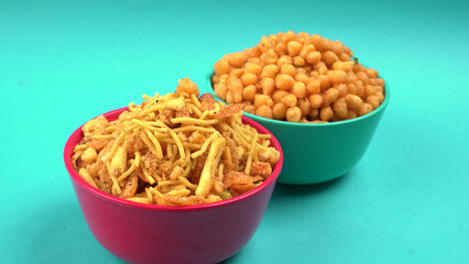 Indian Snacks, Traditional Indian deep fried salty dish called chivda or mixture or farsan made of gram flour and mixed with dry fruits and roasted nuts with salt, pepper, pulses, spice and green peas