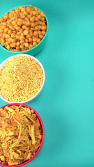 Indian Snacks, Traditional Indian deep fried salty dish called chivda or mixture or farsan made of gram flour and mixed with dry fruits and roasted nuts with salt, pepper, pulses, spice and green peas