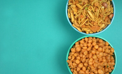 Indian Snacks, Traditional Indian deep fried salty dish called chivda or mixture or farsan made of gram flour and mixed with dry fruits and roasted nuts with salt, pepper, pulses, spice and green peas