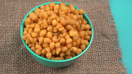 Indian Snacks, Traditional Indian deep fried salty dish called chivda or mixture or farsan made of gram flour and mixed with dry fruits and roasted nuts with salt, pepper, pulses, spice and green peas