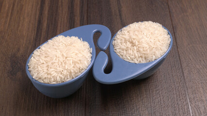 Healthy food. Wooden bowl with parboiled rice on white background. Top view, copy space, high resolution product.
