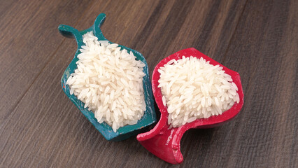 Healthy food. Wooden bowl with parboiled rice on white background. Top view, copy space, high...