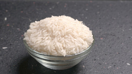 Healthy food. Wooden bowl with parboiled rice on white background. Top view, copy space, high...