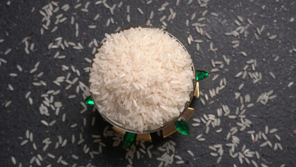 Healthy food. Wooden bowl with parboiled rice on white background. Top view, copy space, high...