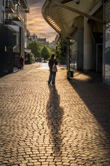 Paris, France - 05 12 2025: Châtelet les Halles. Silhouette of a young girl from behind, backlit...
