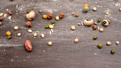 Uncooked pulses,grains and seeds in colourful bowl over wooden background. selective focus
