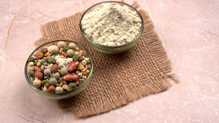 Uncooked pulses,grains and seeds in colourful bowl over wooden background. selective focus