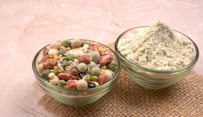 Uncooked pulses,grains and seeds in colourful bowl over wooden background. selective focus