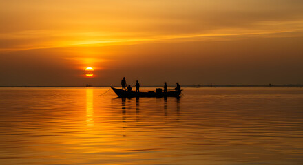 Silhouette of Fishermen in Boat at Sunset