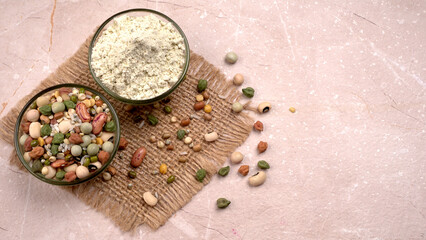 Uncooked pulses,grains and seeds in colourful bowl over wooden background. selective focus