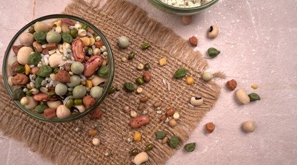 Uncooked pulses,grains and seeds in colourful bowl over wooden background. selective focus