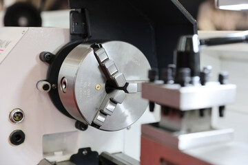 A lathe for making precision mechanical parts is presented to the general public at a machine and tool fair.