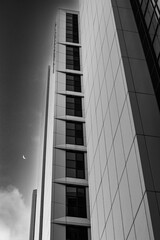 Large modern office block with crescent moon in black and white