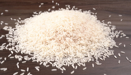 Healthy food. Wooden bowl with parboiled rice on white background. Top view, copy space, high...