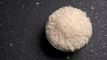 Healthy food. Wooden bowl with parboiled rice on white background. Top view, copy space, high...