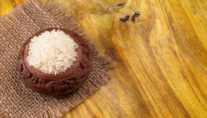 Healthy food. Wooden bowl with parboiled rice on white background. Top view, copy space, high...