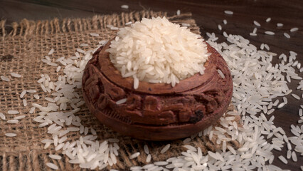 Healthy food. Wooden bowl with parboiled rice on white background. Top view, copy space, high resolution product.
