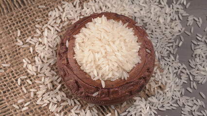 Healthy food. Wooden bowl with parboiled rice on white background. Top view, copy space, high resolution product.
