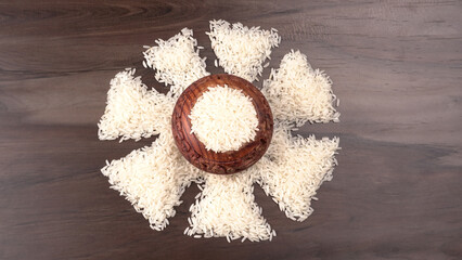 Healthy food. Wooden bowl with parboiled rice on white background. Top view, copy space, high resolution product.
