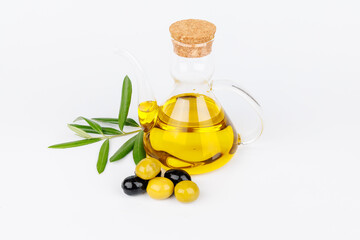 Olive oil and olives styled with olive twigs on a clean white background for food concept