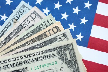 American US dollars money bills and on American flag close up